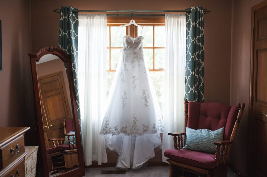 dress hanging in the window {batavia wedding photographer}