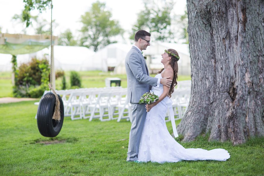 first look between the bride and groom by the tire swing 