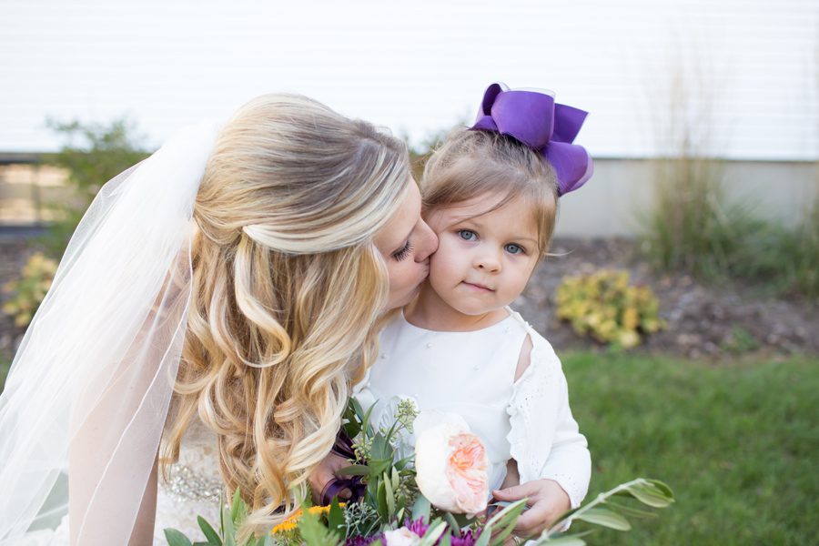 bride kisses the flower girl – Heritage farm
